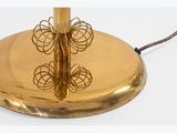 a gold plate with a butterfly on it on a white surface