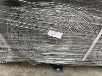 several rolls of wire wrapped in plastic on top of a table