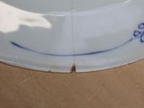 a close up of a white plate with a blue border