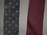 three ties with birds on them hanging on a wall