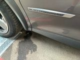 a close up of a car ' s door handle on the side of the road