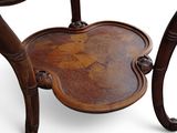 a wooden table with a carved top and a wooden base