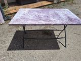 a table that has a purple marble top on it