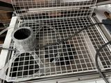 a metal basket that is on top of a stove