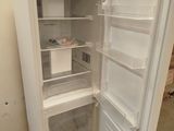 a white refrigerator with its door open in a room