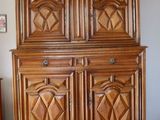 une photo d'une armoire en bois dans un coin d'une pièce