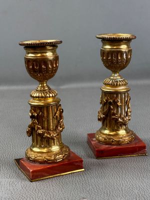 pair of antique brass candlesticks on red marble bases