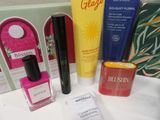 a bottle of nail polish, a bottle of sunscreen, a bottle of sunscreen, and a bottle of sunscreen on a counter