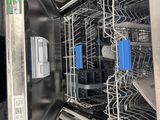 a dishwasher that is open and has a lot of dishes in it