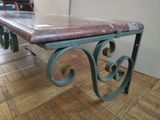 a table with a marble top sitting on a wooden floor