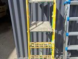 two ladders next to each other in front of a building