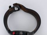 a close up of a watch with a leather band on a white surface