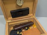 a wooden box with a clock and other items in it
