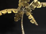 a close up of a metal palm tree on a black background