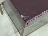 a table with a glass top and a metal base