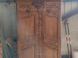 a large wooden cabinet in the middle of a room