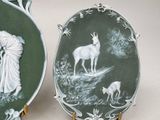 two plates with a picture of a woman and a goat