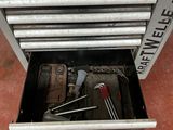 a tool box with tools inside of it on the floor