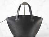 a black leather tote bag on a white background
