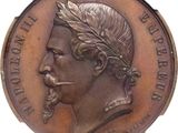 an old bronze medal of a man with a beard and a laurel