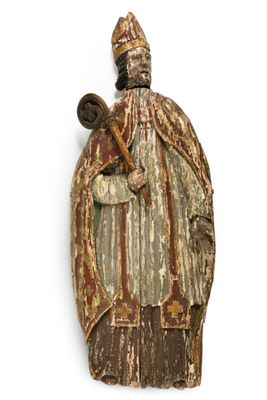an old wooden statue of a man with a hat and a cane