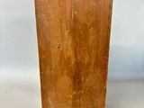 an old wooden box is sitting on a white surface