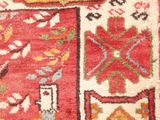 an image of a red and yellow rug with a picture of a man and a woman
