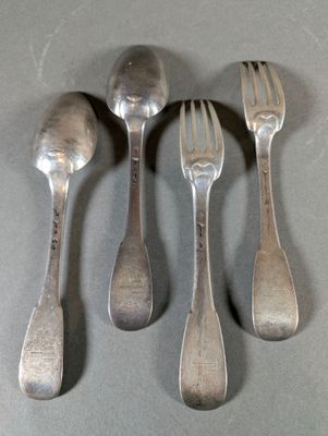 four spoons and a fork are sitting on a table