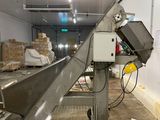 a conveyor belt in a warehouse with boxes on it