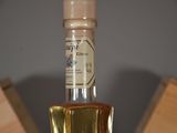 a bottle of liquor sitting on top of a wooden table