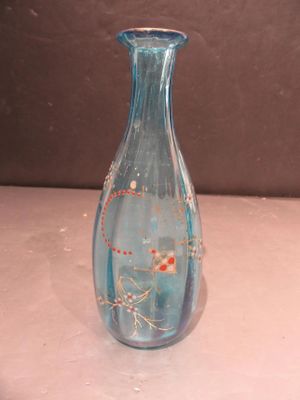 a blue glass vase sitting on a white table