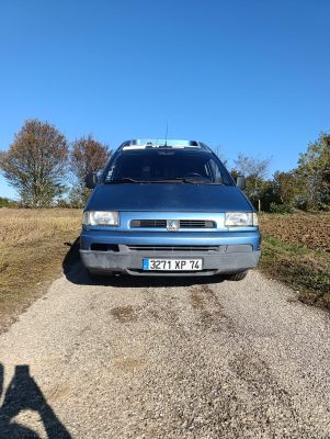 a blue van that is parked on the side of the road
