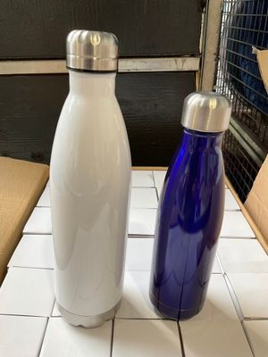 two water bottles sitting on a table next to each other