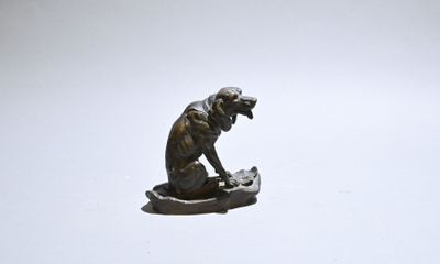 a statue of a monkey sitting on top of a rock