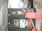 two dvds in a bag with a pink ribbon