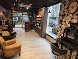 a photo of a salon with chairs and a clock on the wall
