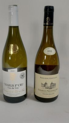 two bottles of wine are sitting next to each other on a table