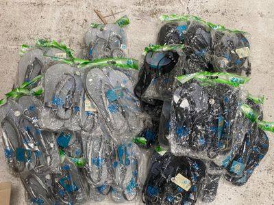 many bags of shoes that have been wrapped in plastic