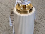 a lamp that is on a table with a tag on it