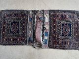 an image of two pieces of old rug on a white surface