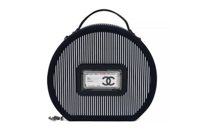 black and white striped bag with a chanel logo on it