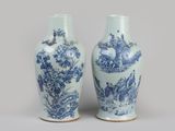 pair of blue and white vases with birds and flowers on them