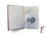 an open book with a picture of a city in it