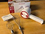 a whisk and a whisk on a table next to a box of whisks