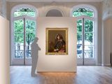 a large painting hanging on the wall in a large room