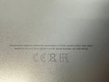 the back of a silver laptop computer with a black keyboard