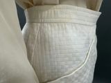 a close up of a white dress with a belt