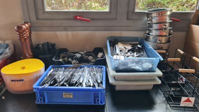 many containers of silverware on the counter in the kitchen