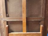 a wooden cabinet that has a door open on the inside