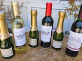 several bottles of wine sitting on top of a wooden table